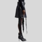 Black leather fringe skirt-side view, highlighting the mesmerizing movement of the fringes