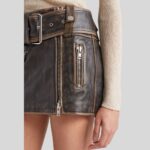 Closeup view of the intricate details of the-brown leather mini skirt