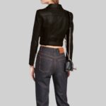 Back view of a-women's black cropped leather jacket