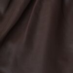 Closeup of the texture of-women's brown leather shorts