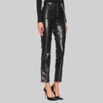 Side view of-women black leather trousers