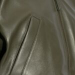 Close-up of pocket on the-emerald leather jacket