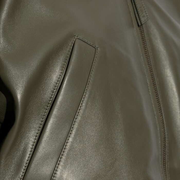 Close-up of pocket on the-emerald leather jacket