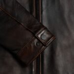 Closeup of cuff design on-men’s black leather outerwear