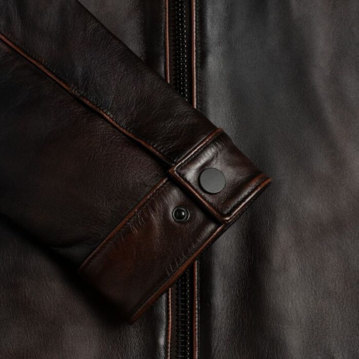 Closeup of cuff design on-men’s black leather outerwear